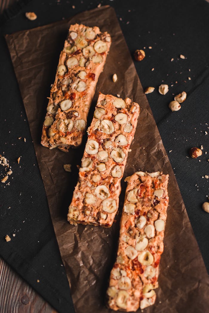 Top view of homemade nut muesli bars on parchment paper, a perfect healthy snack.